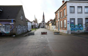 Graffiti-covered buildings with a church in the background