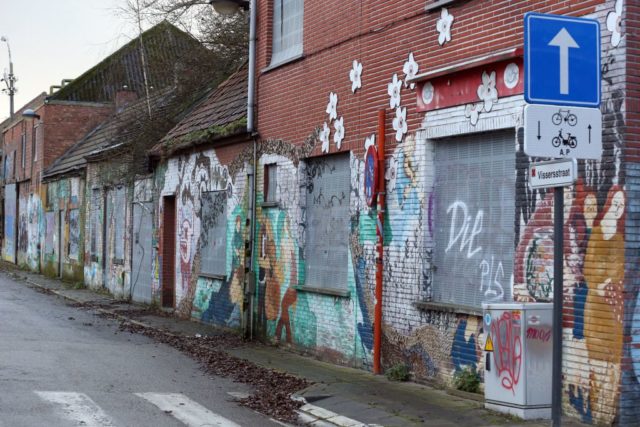Graffiti-covered buildings along a street