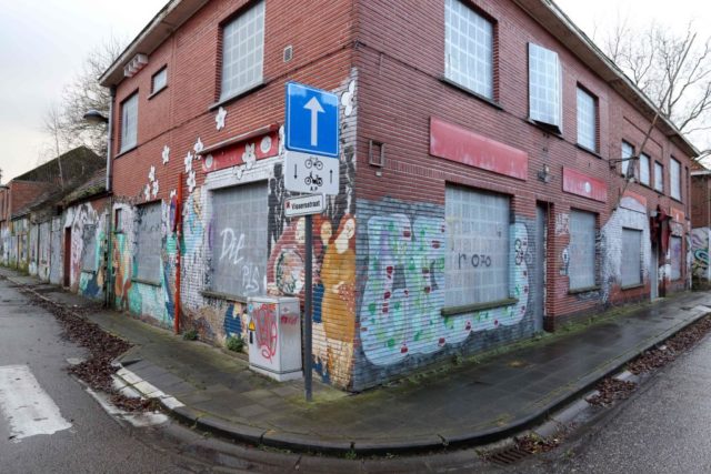 Graffiti-covered building at a street corner