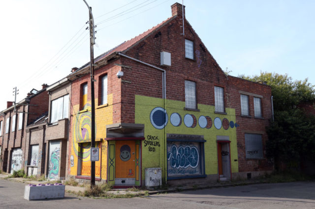 Graffiti-covered building at a street corner