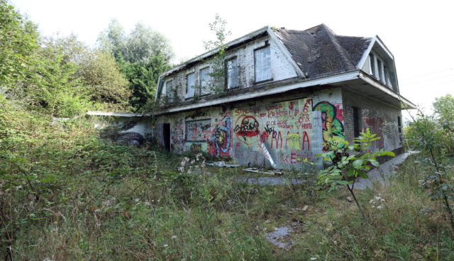 Abandoned house in tall grass