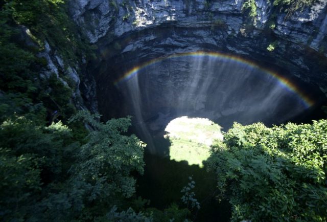 Rainbow over a karst sinkhole