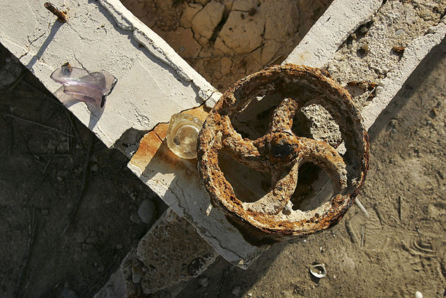 Rusty metal on top of a concrete block