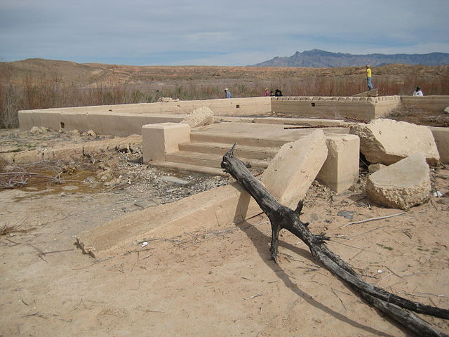 Foundation of a building, with a branch fallen on it