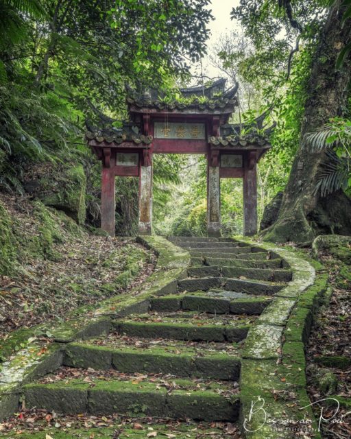 An old stone staircase leads to an oriental-style threshold. 