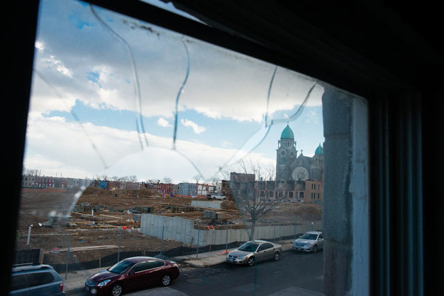 View of a street through a broken window