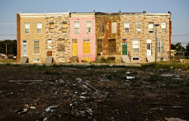 Boarded up houses along a street