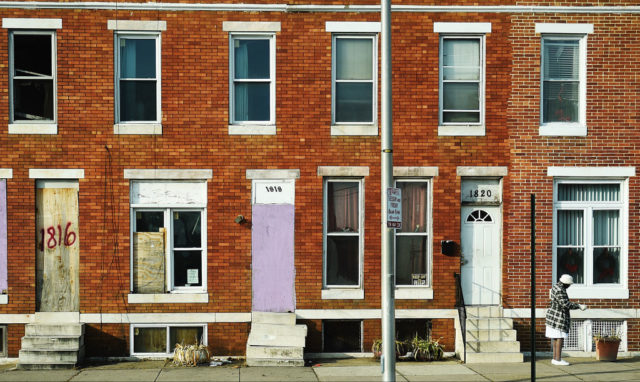 Boarded up houses along a street