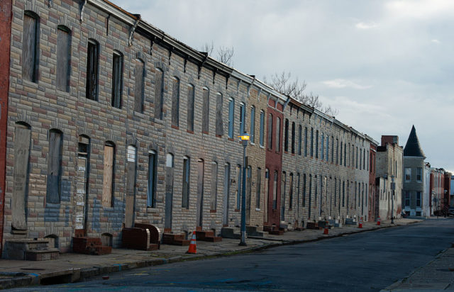 Boarded up houses along a street