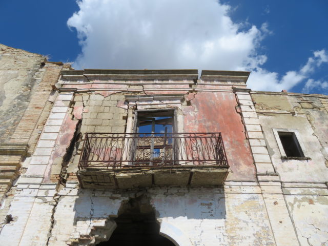 A window experiencing shifting in the abandoned village of Craco, Italy