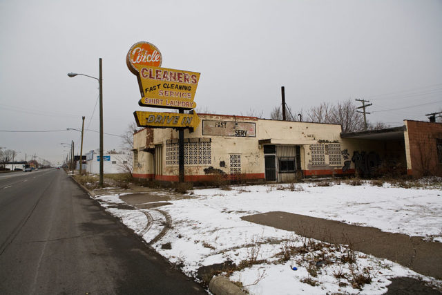 Exterior of a boarded-up dry cleaner