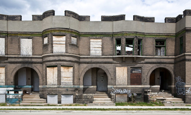 Exterior of boarded-up houses along a street in Detroit