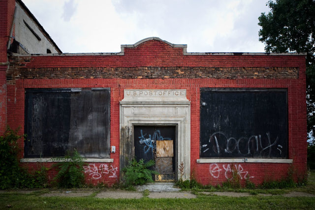 Exterior of a boarded up post office in Detroit