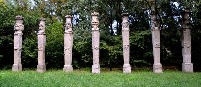 Row of columns with heads carved into them