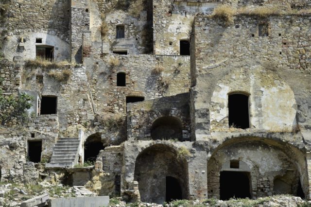 Decaying front of buildings in the abandoned village of Craco, Italy