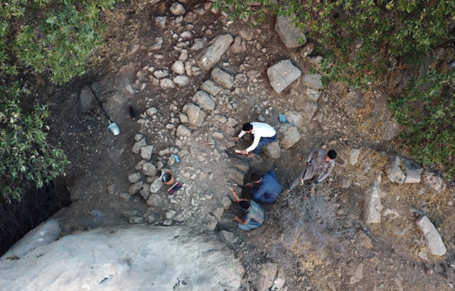 Aerial view of archaeologists digging at an excavation site
