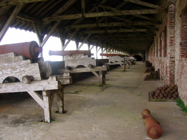 Cannons lined up inside a shed
