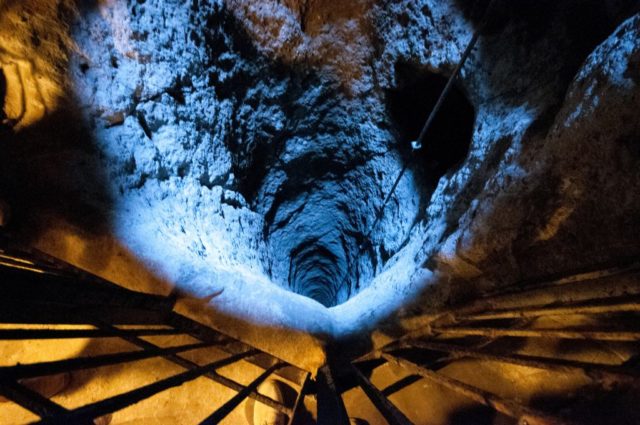 A deep tunnel leads underground