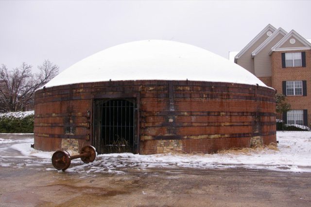 Apartment building behind a beehive kiln at Guignard Brick Works