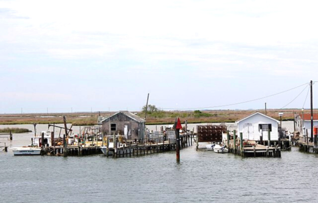 Boats docked outside buildings in the middle of a waterway