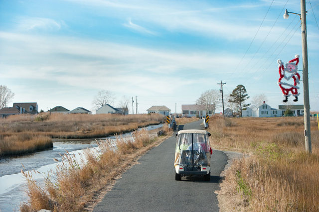 Golf cart driving down a road on Tangier Island