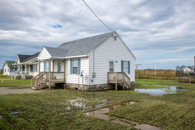 House with a flooded yard on Tangier Island