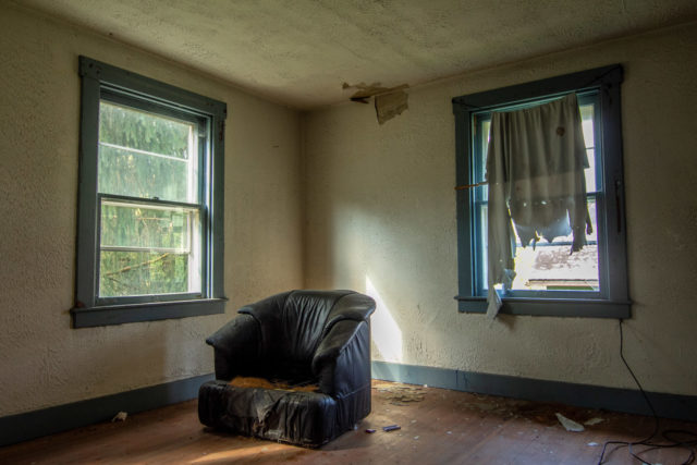 Broken chair in the corner of a room