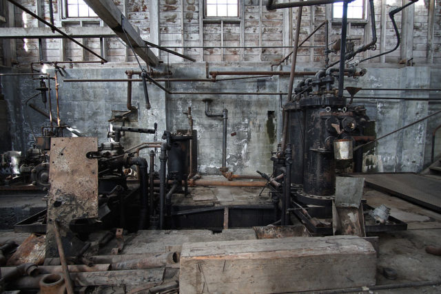 Old, broken down machines insde the abandoned Kennecott power plant