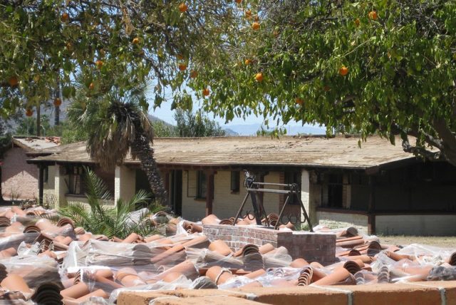 Large pile of red roof tiles sitting in front of the Ghost Ranch Lodge building.