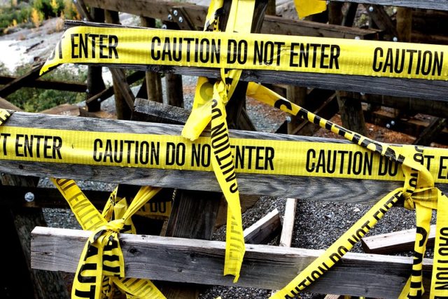 Caution tape reads CAUTION DO NOT ENTER