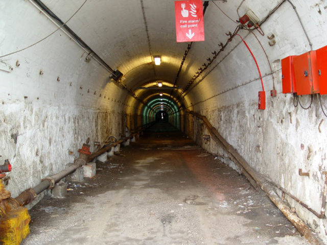 View into the Admiralty Tunnel with white walls and piping. 