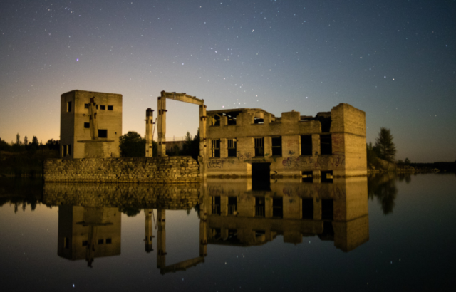 The ruins of Rummu prison and quarry under a starry night sky