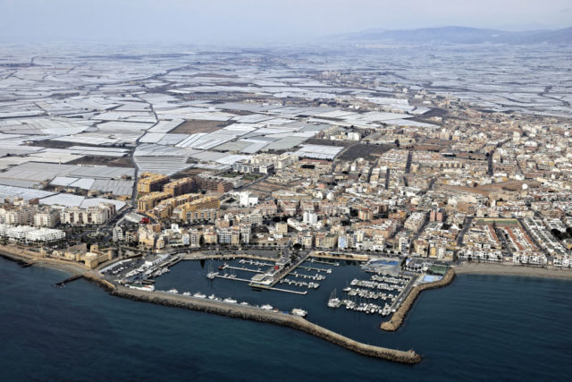 Port city of Roquetas de Mar with miles of greenhouses fading into the background.