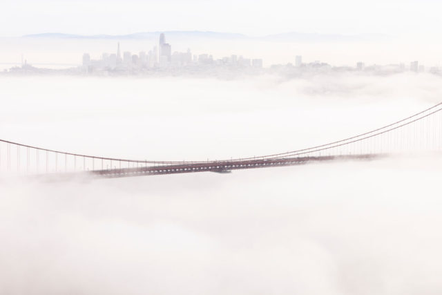 Golden Gate Bridge peaking through heavy fog.