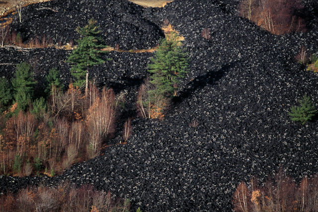 Aerial shot of a large number of tires in a landfill.