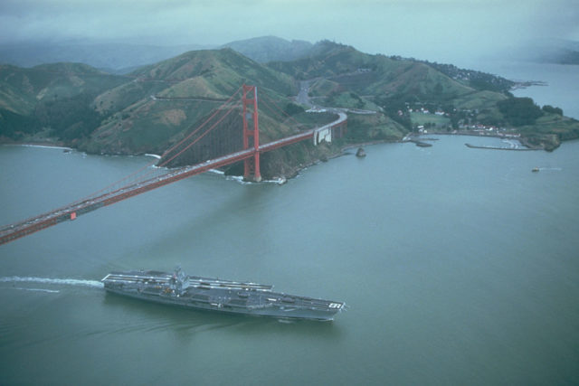 USS Enterprise aircraft carrier traveling under the Golden Gate Bridge. 