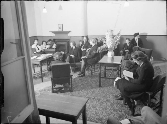 Group of women sitting inside a room socializing. 
