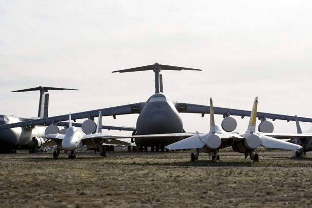 Lockheed C-5 Galaxy parked beside a number of Grumman F-14 Tomcats