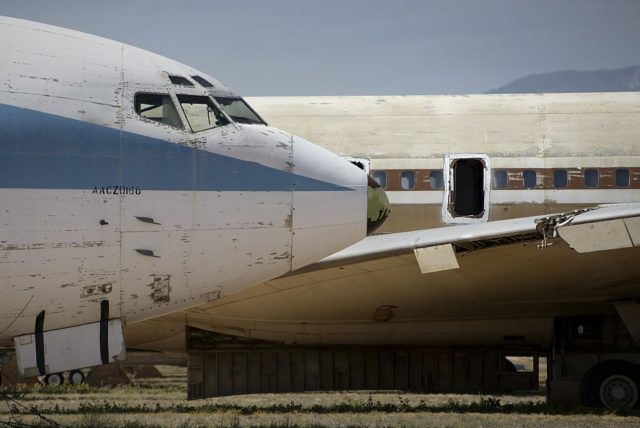 Two passenger jets parked beside each other outside