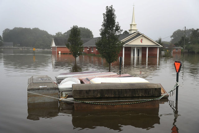 Coffins floating in floodwaters