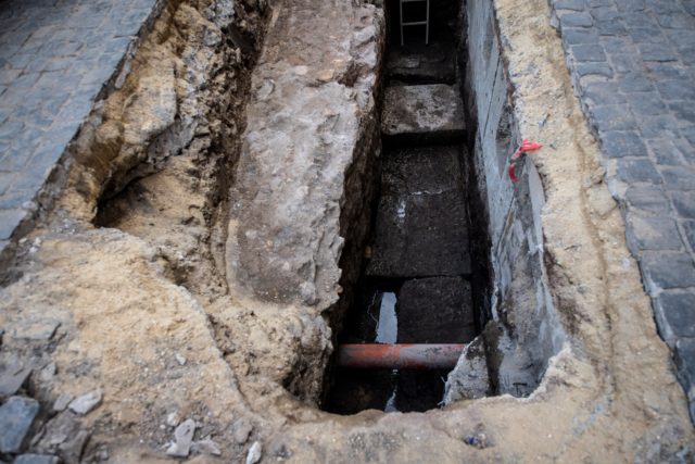 Stone slabs sitting in the bottom of the hole