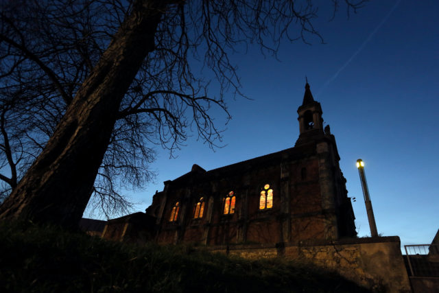 A Spanish church's exterior photographed as dusk