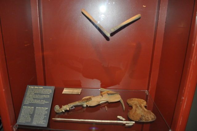 Violins and other instruments in a display case