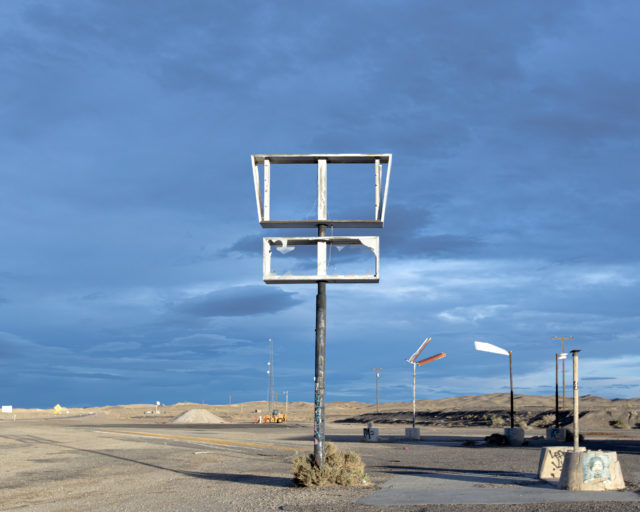 Broken sign along the side of a road