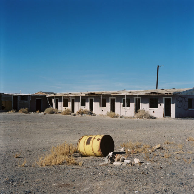 Rusty barrel on the outskirts of an abandoned motel