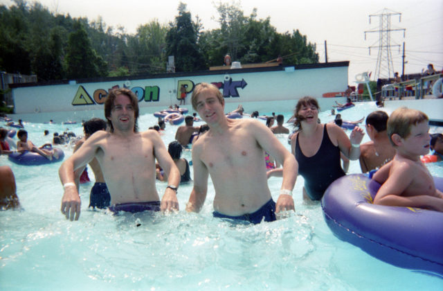 Two men pose for a photo in the Action Park wave pool
