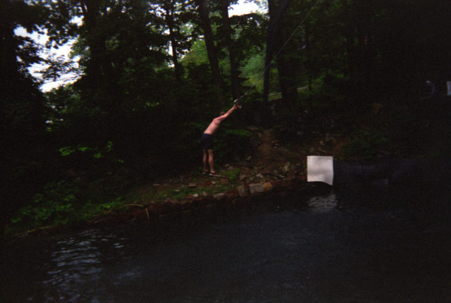 A visitor uses the rope swing at Action Park