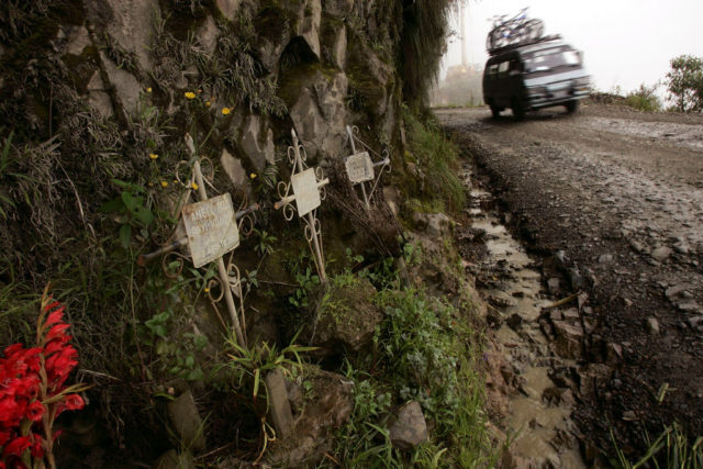 Van driving past three crosses along Death Road