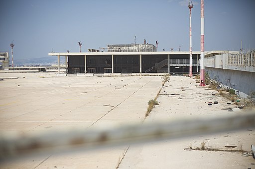 Old building at Ellinikon International Airport with a large stretch of pavement in front of it.