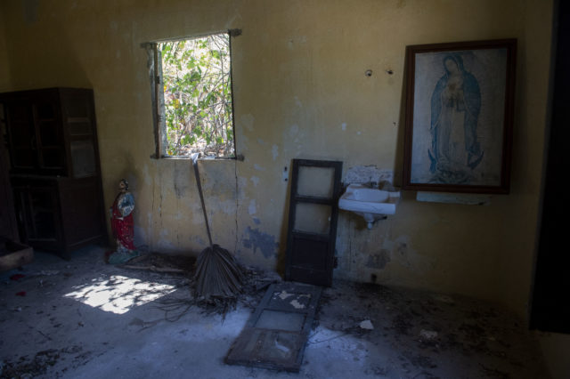 Several object sit in an abandoned, derelict room